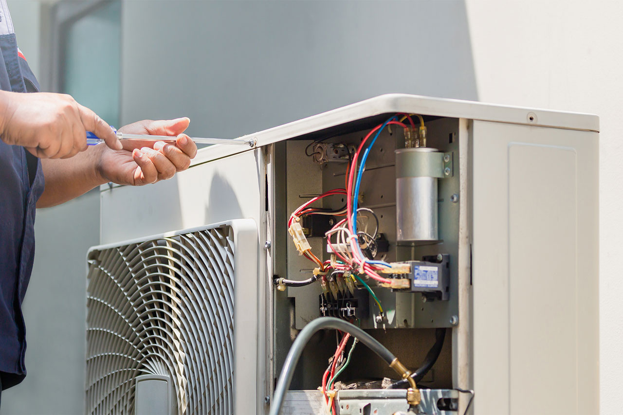HVAC technician servicing residential cooling equipment
